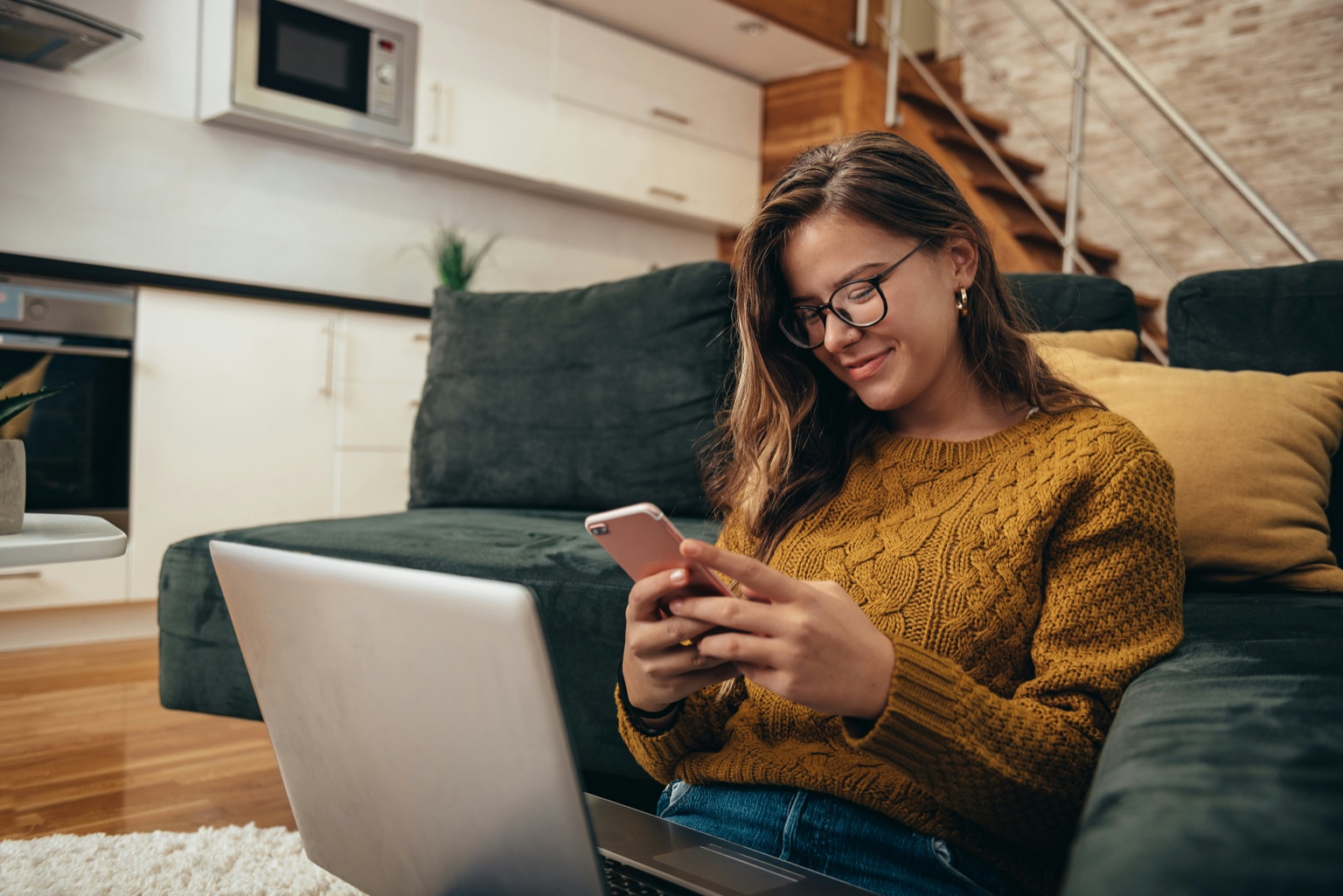 A young customer in a mustard sweater texting from her couch, like a real post-delivery reply moment.